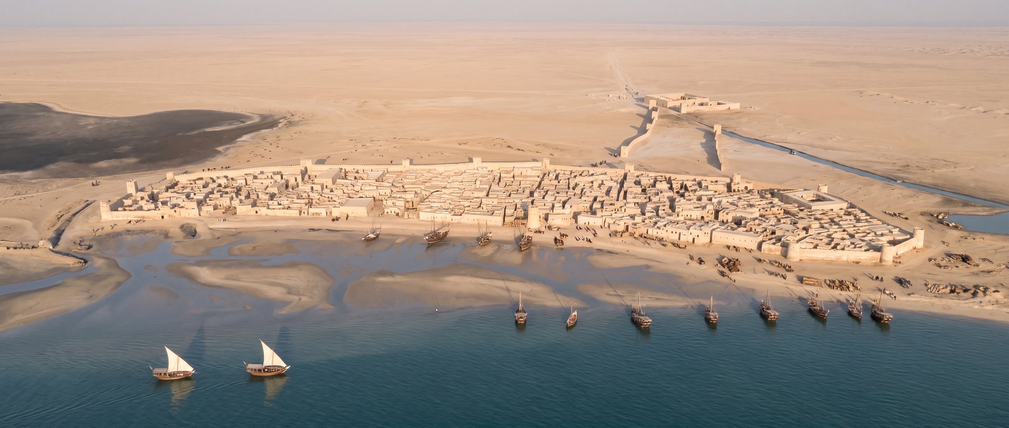The walled town of Al Zubarah from the sea, with dhows at anchor and two under sail, 1780s